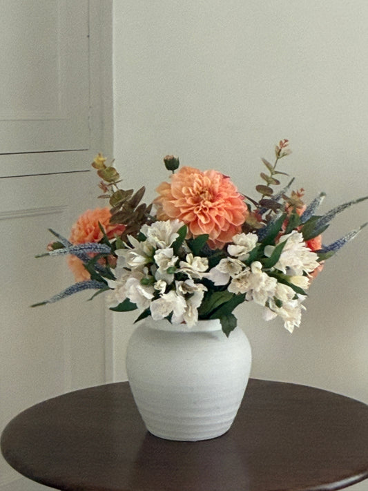 The Lassell faux floral arrangement with orange Dahlias, blue Veronica, cream Alstroemerias and Eucalyptus sprays in a mix of green and brown tones.
