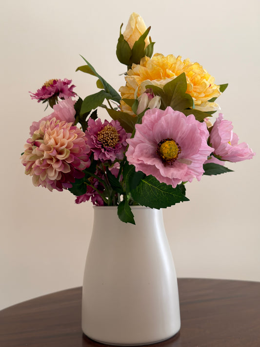 Faux floral bouquet of pink Scabiosas, yellow peonies, pink Poppies, fuchsia and nude Pom Pom Dahlias, style in small vase or jug.