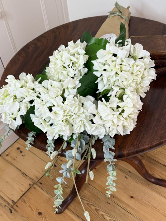 Faux floral real touch tall elegant bouquet of ivory garden Hydrangeas, Eucalyptus & Pussy Willow. Wedding florals, year round beauty for the home, wrapped in stylish brown paper..